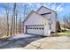 Attached garage with driveway and wooded backdrop at 1485 Adkin Dr, Iron Station, NC 28080