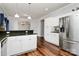 White kitchen with granite countertops and stainless steel appliances at 1485 Adkin Dr, Iron Station, NC 28080
