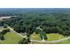 Expansive aerial view of a wooded property with a home nestled among lush greenery and mature trees at 1769 Old Nc 27 Hwy, Mount Holly, NC 28120