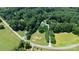 Aerial view of a wooded lot with a long driveway to a home near a road at 1769 Old Nc 27 Hwy, Mount Holly, NC 28120