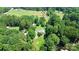 Aerial view of home with lush trees and manicured lawns, a tranquil country setting at 1769 Old Nc 27 Hwy, Mount Holly, NC 28120
