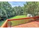 This wooden deck offers beautiful views of the backyard and surrounding greenery at 1769 Old Nc 27 Hwy, Mount Holly, NC 28120
