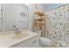 Well-lit bathroom with floral shower curtain, patterned floor, and white single sink vanity at 1769 Old Nc 27 Hwy, Mount Holly, NC 28120