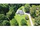 A residence on a well-maintained lot amid mature trees, highlighted in an aerial shot at 1769 Old Nc 27 Hwy, Mount Holly, NC 28120