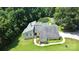 Aerial view of home surrounded by a landscaped yard, mature trees and a backdrop of lush greenery at 1769 Old Nc 27 Hwy, Mount Holly, NC 28120