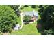 Aerial view of home with attached deck and outbuilding on a large grassy lot at 1769 Old Nc 27 Hwy, Mount Holly, NC 28120