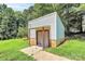 Exterior view of a small outbuilding or shed with a red trim at 1769 Old Nc 27 Hwy, Mount Holly, NC 28120