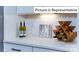 White kitchen counter with wine rack and hexagon tile backsplash at 2019 Canvasback Way, Indian Trail, NC 28079