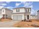 Two-story house with gray siding, double garage, and landscaping at 226 J.P. Dr, Albemarle, NC 28001