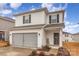 Two-story house with gray siding, double garage, and landscaping at 226 J.P. Dr, Albemarle, NC 28001
