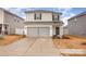 Two-story house with gray siding, double garage, and landscaping at 226 J.P. Dr, Albemarle, NC 28001