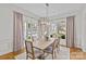 Inviting dining room with a modern chandelier, hardwood floors, and large windows, ideal for entertaining guests in style at 228 Heathwood Rd, Charlotte, NC 28211