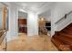 Basement entry with tile floors, leading to a wet bar and Gathering room with a stone fireplace at 4827 Camilla Dr, Charlotte, NC 28226