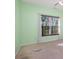 Bedroom with green walls, a ceiling fan, carpeted floors, and a large window at 5022 Saybrook Dr, Harrisburg, NC 28075