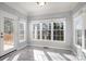 Bright dining area with many windows and a door to the outside deck at 5022 Saybrook Dr, Harrisburg, NC 28075