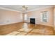 Bright living room features hardwood floors, fireplace, and natural light from large windows at 5022 Saybrook Dr, Harrisburg, NC 28075