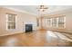 Inviting living room with fireplace and large windows, creating a warm ambiance at 5022 Saybrook Dr, Harrisburg, NC 28075