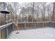 View from the back deck with wood railings looking out to the wooded backyard of the property at 6726 Wannamaker Ln, Charlotte, NC 28226