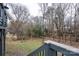 Wooded backyard view from the deck with gray railings and trees lining the property at 6726 Wannamaker Ln, Charlotte, NC 28226