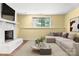 Finished basement with a fireplace, comfortable seating, and a window providing natural light at 6726 Wannamaker Ln, Charlotte, NC 28226