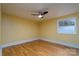 Bright bedroom features a ceiling fan and hardwood floors at 6726 Wannamaker Ln, Charlotte, NC 28226