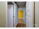 Hallway view of a bedroom with hardwood floors and brightly colored walls at 6726 Wannamaker Ln, Charlotte, NC 28226