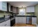 The updated kitchen boasts stainless steel appliances, sleek gray cabinetry, and ample counter space at 6726 Wannamaker Ln, Charlotte, NC 28226