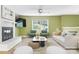 Bright living room with a white brick fireplace, plush seating, and large windows with verdant views at 6726 Wannamaker Ln, Charlotte, NC 28226