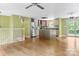 Open floor plan flows into the kitchen with island, stainless steel appliances, and sliding doors to the backyard at 6726 Wannamaker Ln, Charlotte, NC 28226