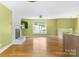 Expansive living room with white fireplace, large windows, and open access to the kitchen area, bathed in natural light at 6726 Wannamaker Ln, Charlotte, NC 28226