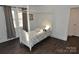 Charming bedroom with a white four-poster bed and hardwood floors at 733 Azalea Dr, Chester, SC 29706