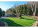 Landscaped backyard with artificial turf and stone pathway at 10439 Donahue Dr, Huntersville, NC 28078