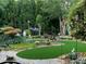 Landscaped backyard with artificial turf and colorful flowers at 10439 Donahue Dr, Huntersville, NC 28078