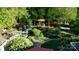 Elevated view of a lush backyard oasis with stone paths at 10439 Donahue Dr, Huntersville, NC 28078