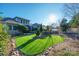 Backyard with artificial turf, stone accents, and home view at 10439 Donahue Dr, Huntersville, NC 28078