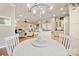 Charming dining area with a round table, white chairs, and a chandelier at 10439 Donahue Dr, Huntersville, NC 28078