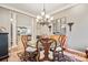 Formal dining room with a glass-top table and chandelier at 10439 Donahue Dr, Huntersville, NC 28078