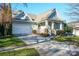 Charming craftsman style home with two-car garage and landscaped lawn at 10439 Donahue Dr, Huntersville, NC 28078