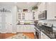 Modern kitchen with granite countertops and white shaker cabinets at 10439 Donahue Dr, Huntersville, NC 28078