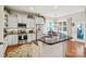 Modern kitchen with granite countertops, white cabinets and stainless steel appliances at 10439 Donahue Dr, Huntersville, NC 28078