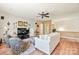 Bright living room with hardwood floors, comfortable seating, and a ceiling fan at 10439 Donahue Dr, Huntersville, NC 28078