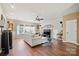 Spacious living room featuring hardwood floors, comfortable seating, and a large TV at 10439 Donahue Dr, Huntersville, NC 28078