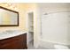 Updated bathroom with marble vanity, subway tile shower, and alcove shelving at 106 N Battleground Ave, Kings Mountain, NC 28086