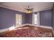 Bright bedroom with hardwood floors, ceiling fan, and access to sunroom at 106 N Battleground Ave, Kings Mountain, NC 28086