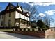 Two-story home with wraparound porch and brick wall at 106 N Battleground Ave, Kings Mountain, NC 28086