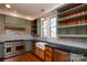 Kitchen with farmhouse sink, stainless steel appliances, and open shelving at 106 N Battleground Ave, Kings Mountain, NC 28086