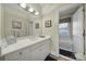 Bathroom featuring a tub, white vanity, a large mirror and neutral walls and decor at 115 Amelia Ln # 29, Mooresville, NC 28117