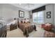 Bedroom with a comfortable bed, neutral walls, and a window with shutter-style blinds at 115 Amelia Ln, Mooresville, NC 28117