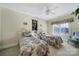 Bedroom with twin beds, floral bedding, neutral walls, and a window with shutter-style blinds at 115 Amelia Ln, Mooresville, NC 28117