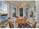 Bright breakfast nook with a round wood table, pendant lighting, and large windows providing ample natural light at 115 Amelia Ln, Mooresville, NC 28117